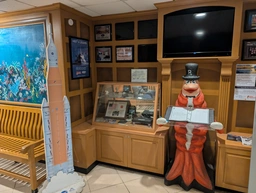 space shuttle stuff next to a giant shrimp statue with a top hat