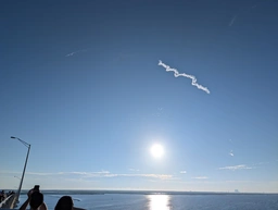 the rocket shot up in a slow, wide curve to the left, soon barely visible as a thin streak