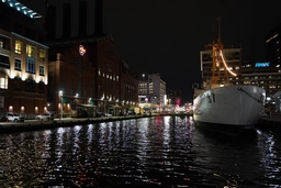 one of the ships in the harbor next to the Hard Rock cafe at night