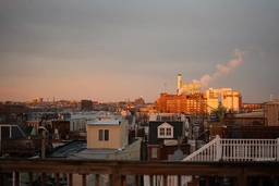 up on one of the rooftop decks overlooking the harbor with the Domino Sugar sign